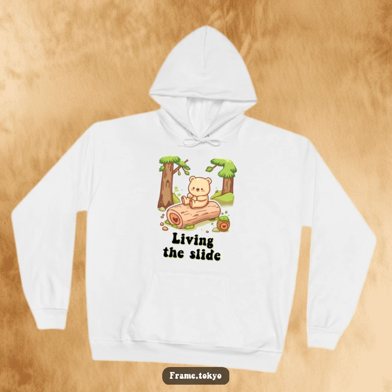 Funny bear hoodie featuring a happy bear shuffling joyfully while sliding down a mossy log, a scene of pure delight.