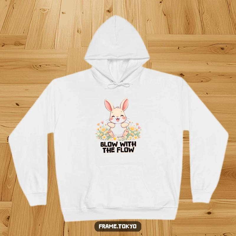 Funny hoodie featuring a happy rabbit with a wide grin, joyfully rolling in a field of tiny, glowing flowers.