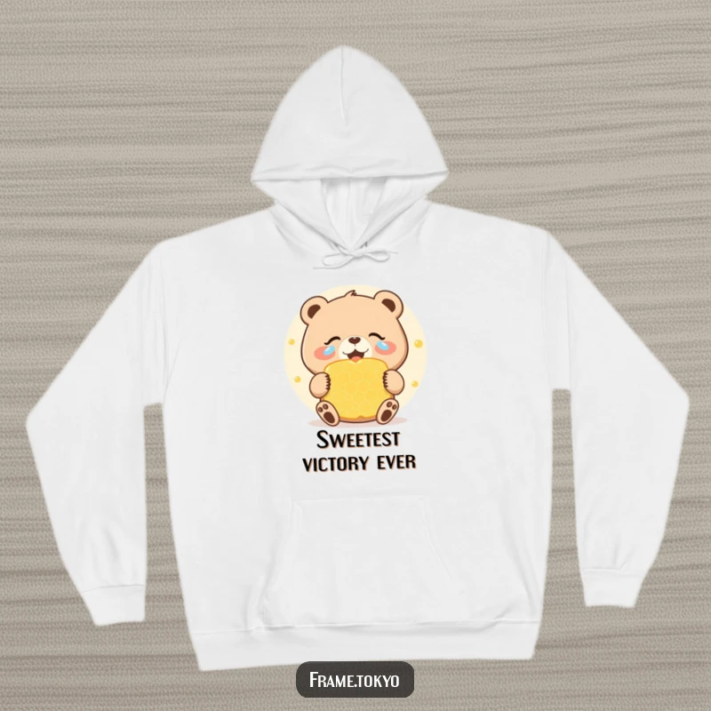 Funny hoodie showing a bear with joyous tears celebrating a giant, sweet honeycomb, a humorous and cozy design for sweet lovers.