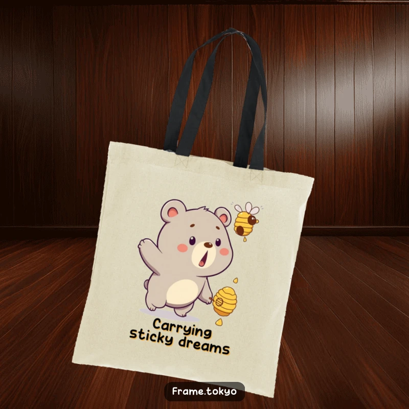 Funny bear tote bag showing a surprised bear comically chasing a floating, dripping beehive, perfect for carrying humor.